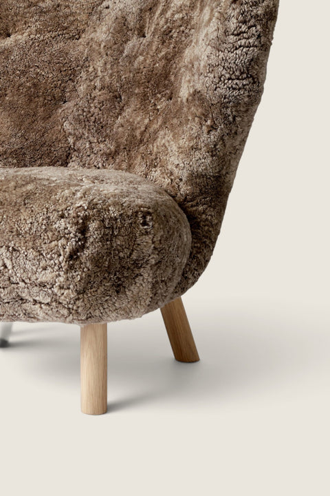 Bolina Little Petra lounge chair in Sahara brown sheepskin with light oak legs, a classic Danish design piece.