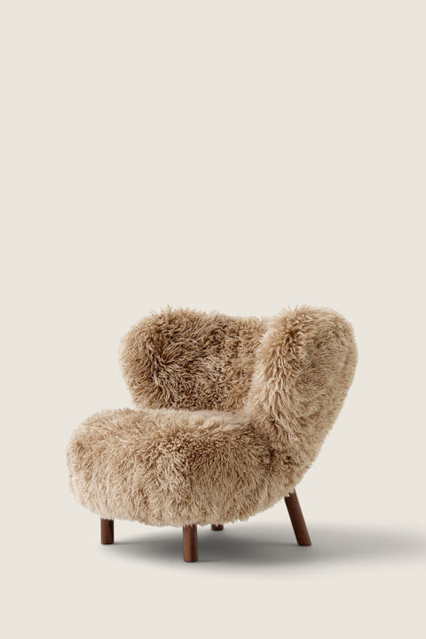 Bolina Little Petra lounge chair in honey sheepskin with oiled walnut legs, a classic Danish design by Viggo Boesen.