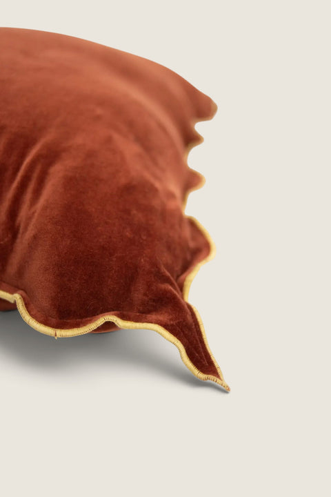 Bolina Lola rust velvet cushion cover with a wavy edge and contrasting yellow stitching, 50x50cm square design.