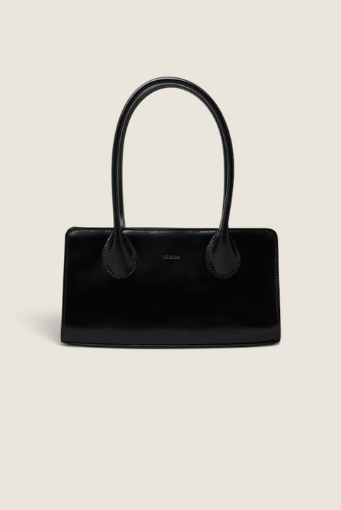 Bolina Lou bag in black patent leather with a slim, elongated shape and long shoulder straps.