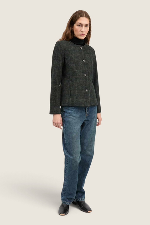 Bolina Mabel wool jacket in green check with round neck and button front, worn by a model with jeans.
