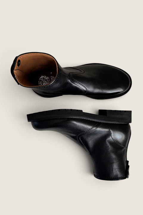 Bolina Megan short black leather boots with a thick rubber sole and back zipper closure, viewed from above and side.