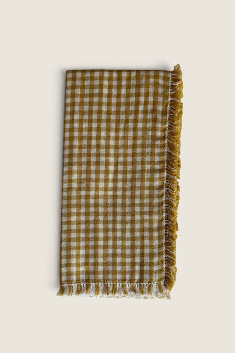 Bolina mustard and white small gingham cotton napkin with decorative fringed edges for a warm table setting.