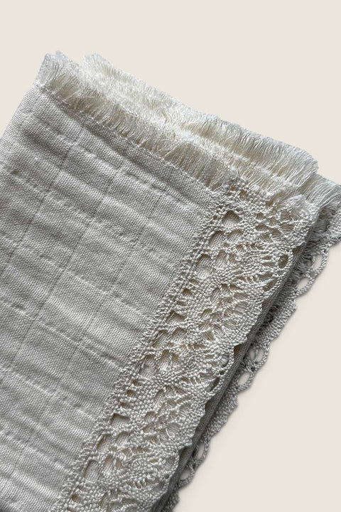 Bolina natural cotton napkin featuring delicate lace trim and fringe edges for a romantic table setting.