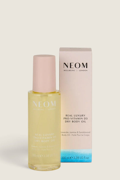 Bolina NEOM Real Luxury Pro-Vitamin D3 dry body oil in a glass bottle with a pink cap and matching product box.