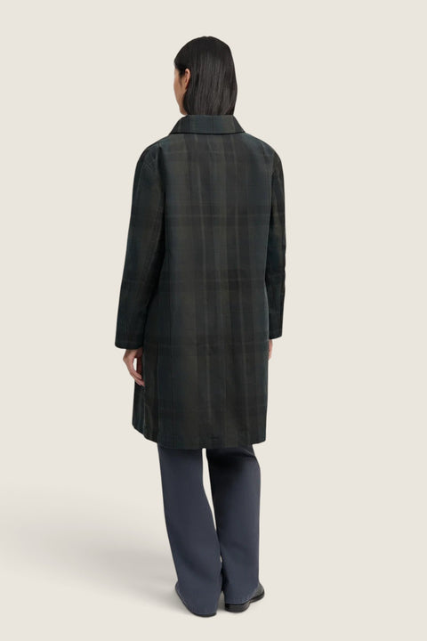 Bolina Noor coat in dark check pattern with a waxed water-repellent finish, worn by a model, back view.