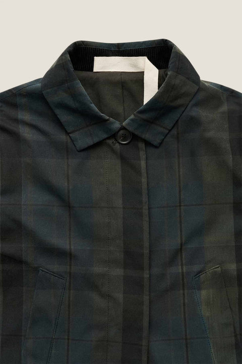 Bolina Noor coat in dark green and black plaid with a waxed finish, small collar, and hidden button placket.