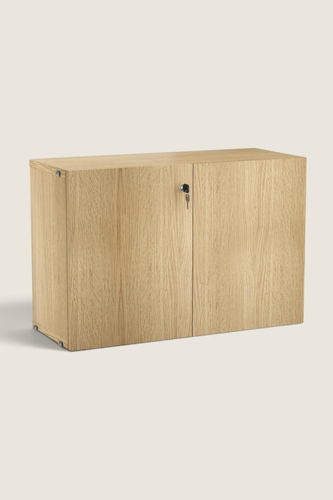 Bolina oak veneer cabinet for String System with two doors, push-open mechanism, and a lock with key.