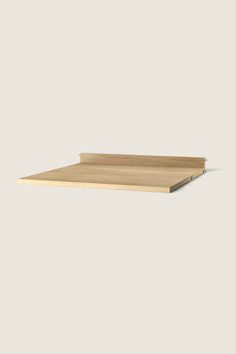 Bolina oak work desk shelf for String System with a natural wood grain finish and a low back edge for stability.