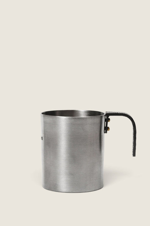Bolina Obra stainless steel measuring cup with a black textured handle and brass rivets, 100ml capacity.