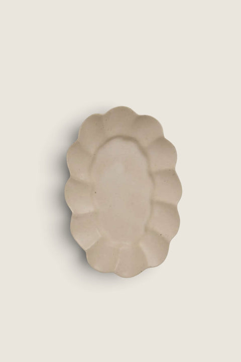 Bolina Paul white stoneware serving dish with a small, oblong shape and soft, wavy scalloped edges.