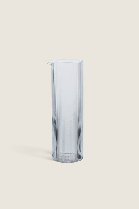 Bolina Ripple clear mouth-blown glass water jug with a tall, slender, and ribbed design for elegant serving.
