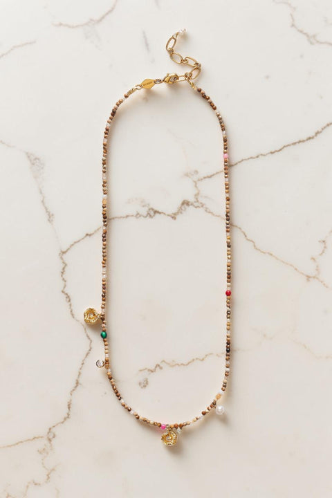 Bolina Sandy Harmony necklace featuring sand-colored beads, freshwater pearls, colorful stones, and gold charms.