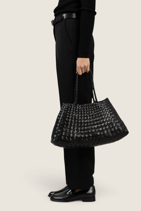 Bolina Santa Croce Big black hand-woven leather tote bag with a basket-weave design held by a model.