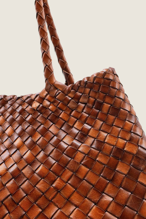 Bolina Santa Croce Big tan woven leather tote bag with braided handles and an open top design.