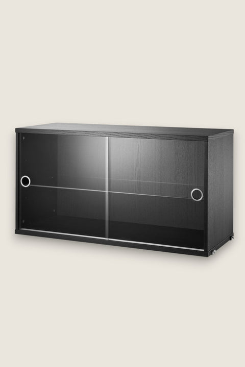 Bolina String glass display cabinet in black ash veneer with sliding glass doors and an internal shelf.