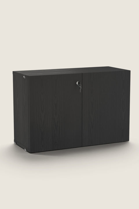 Bolina String System lockable cabinet in black stained ash veneer with two doors and a key in the right lock.