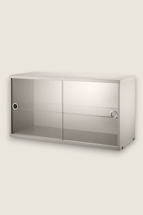 Bolina String System beige display cabinet with sliding glass doors and an adjustable shelf for modular shelving