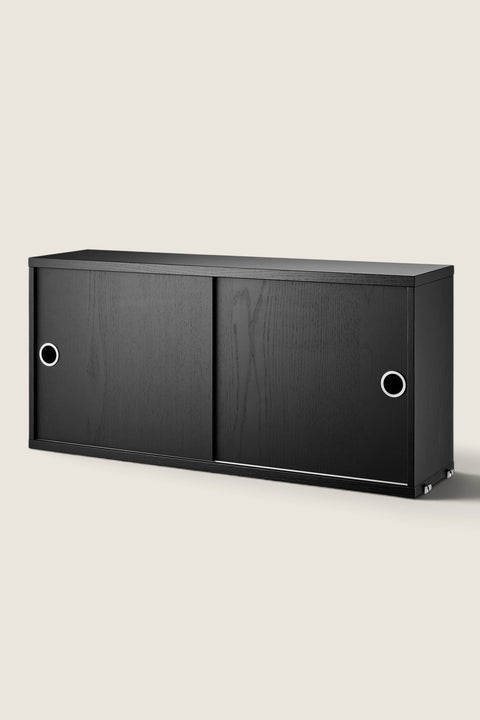 Bolina String System cabinet in black ash veneer with sliding doors and circular metal handles