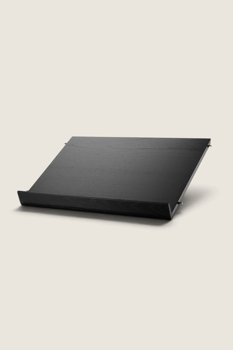 Bolina String System black ash veneer magazine shelf for displaying books and magazines on a 30cm deep wall unit.