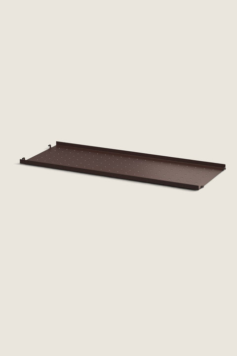 Bolina String System dark brown metal shelf with a low edge and perforated surface for flexible storage solutions.