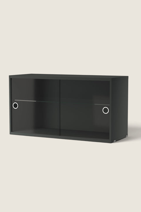 Bolina String System display cabinet in dark grey with glass sliding doors and an internal glass shelf.