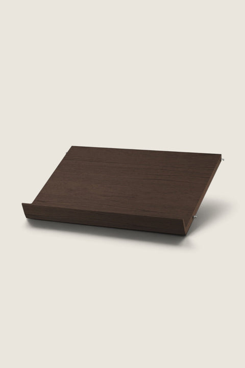 Bolina String System dark oak magazine shelf for 30cm deep panels, ideal for displaying books and magazines.
