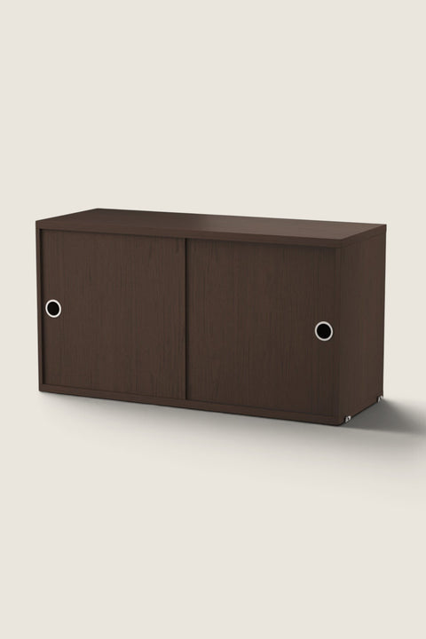Bolina String System storage cabinet in dark oak wood with sliding doors and circular metal handles