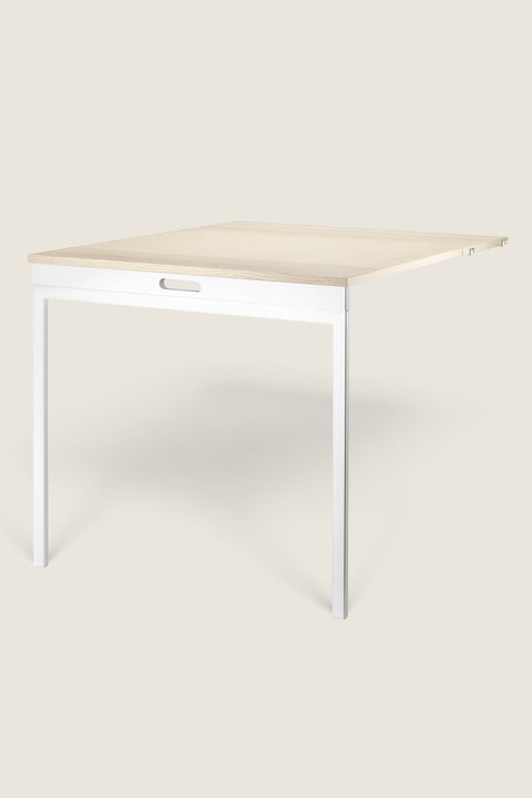 Bolina String System folding table in ash wood and white finish, designed for space-saving wall-mounted shelving.