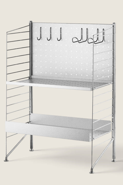 Bolina String System freestanding galvanized steel shelving unit with metal shelves, back panel, and storage hooks.