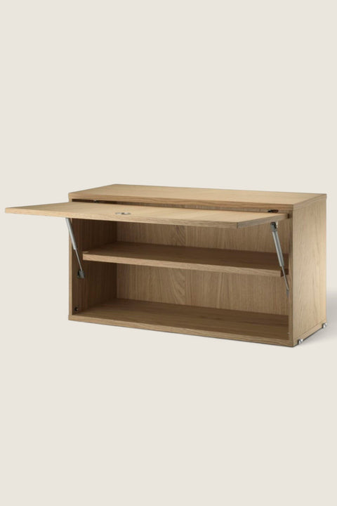 Bolina String System flip door cabinet in oak veneer with an adjustable inner shelf and open door mechanism.