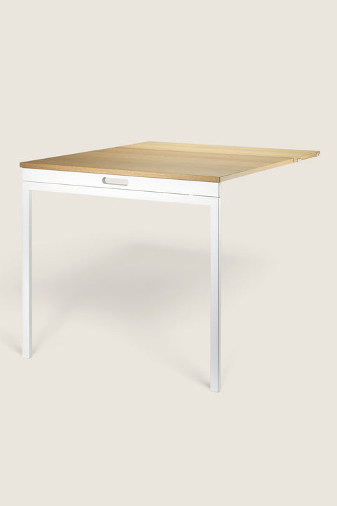 Bolina String System folding table in oak and white, featuring a space-saving design for wall-mounted shelving units.