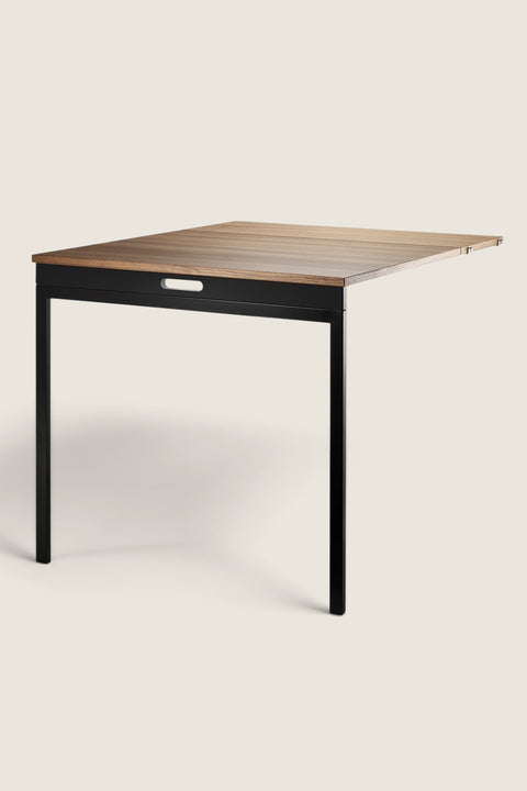 Bolina String System foldable table in walnut wood and black powder-coated steel, shown in an open position.