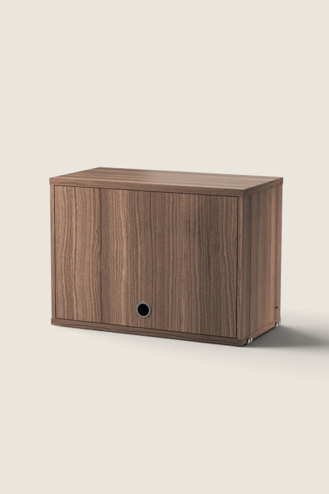 Bolina String System flip door cabinet in walnut veneer with a minimalist design and circular handle