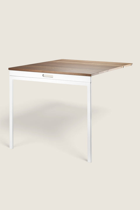 Bolina String System folding table in walnut wood and white frame, perfect for compact home office or dining spaces.