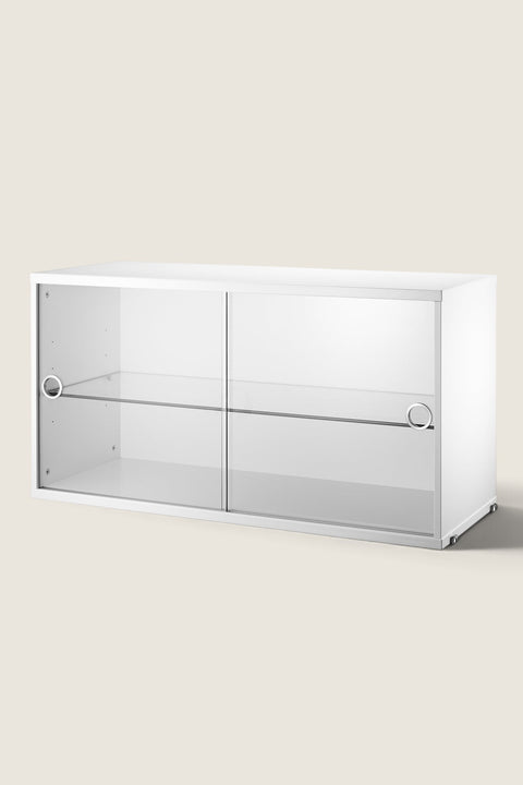 Bolina white String System display cabinet with sliding glass doors and an adjustable shelf for modular shelving.