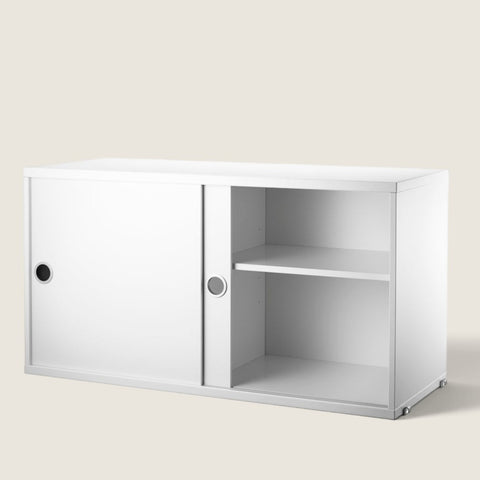 Bolina white String System cabinet with sliding doors and adjustable internal shelving for modular wall storage.