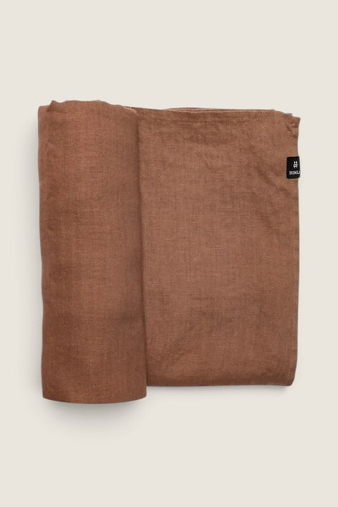 Bolina Sunshine linen tablecloth in Grounded, a muted rose-toned brown with a soft, naturally wrinkled texture.