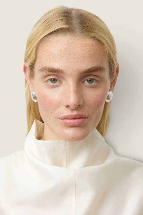 Bolina The Camille silver sculptural oval earrings worn by a model with a polished finish