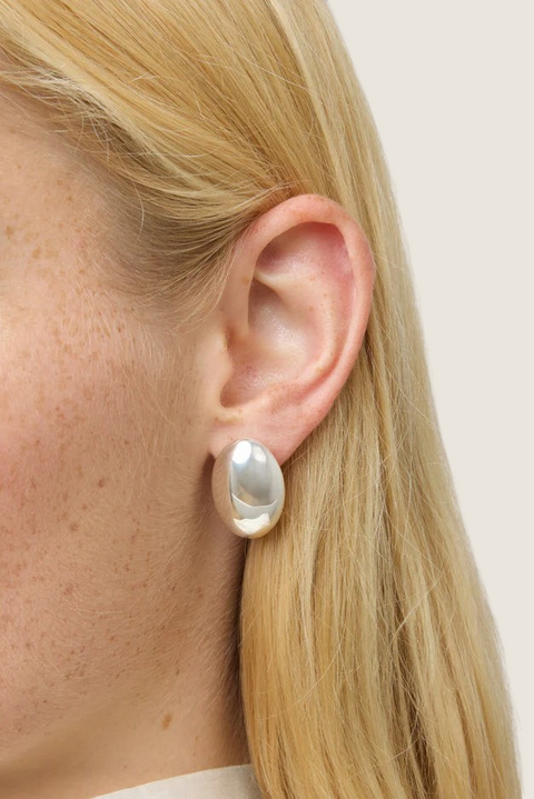 Bolina The Camille silver sculptural oval earrings with a polished finish worn on a model ear