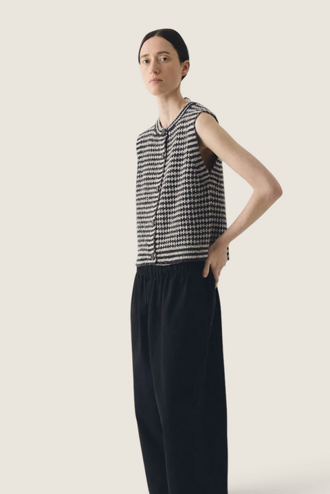 Bolina TOAST striped Donegal merino wool buttoned vest in flax and charcoal worn by a model.