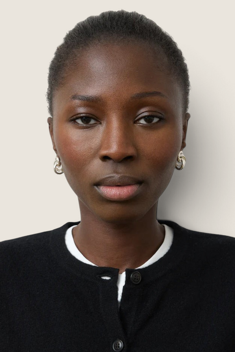 Bolina Vera silver earrings featuring a sculptural knot design worn by a model in a black cardigan