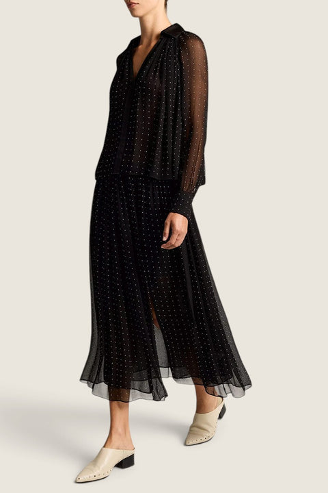Bolina Vince black sheer chiffon midi skirt with white polka dots, gathered waist, and side slit on a model