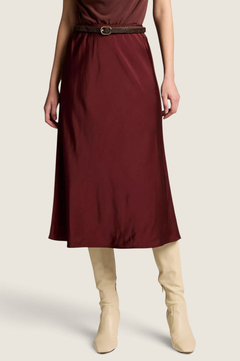 Bolina Vince matte satin slip skirt in black rose featuring an elastic waist and midi length, paired with cream boots
