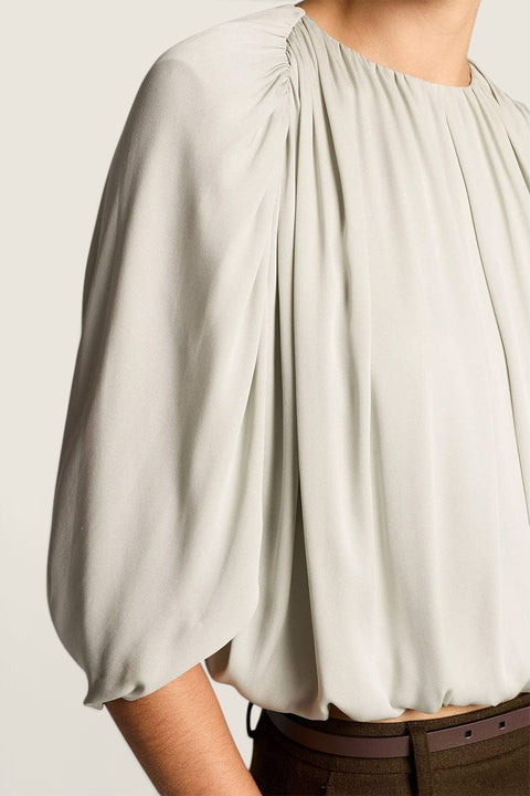 Bolina Vince stone sage green blouse with gathered neckline, cape sleeves, and a subtle sheen finish.