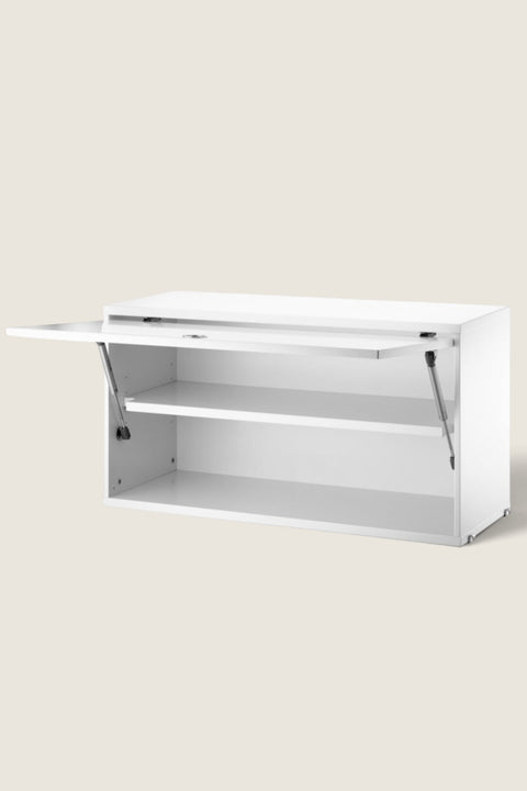 Bolina white String System flip door cabinet with one adjustable shelf, made of lacquered MDF.