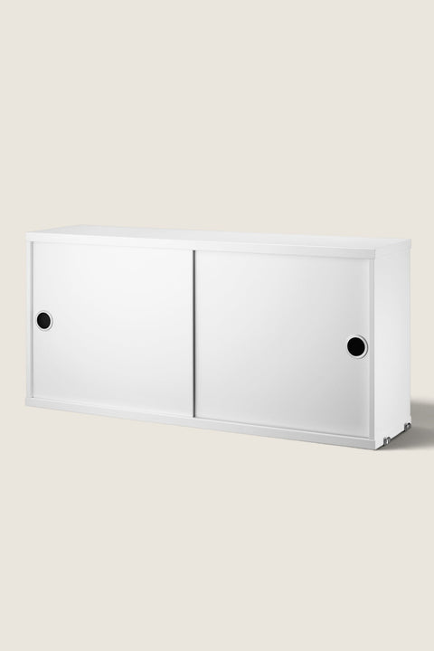 Bolina white String System cabinet with sliding doors and circular handles for modular wall storage