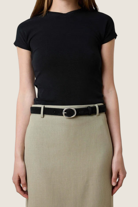 Bolina Wyatt wide black suede belt with a silver oval buckle worn over a beige skirt and black top
