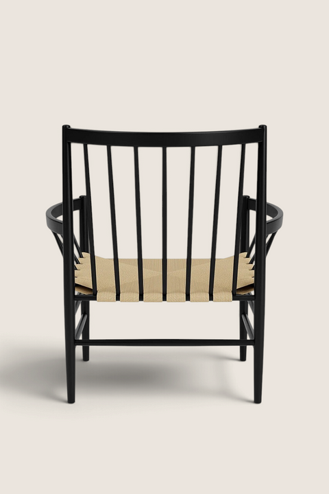 Bolina J82 lounge chair in black beech wood with a woven natural paper cord seat, shown from a rear view.