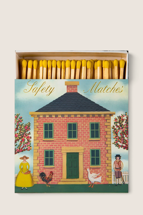 Bolina Archivist safety matches in a decorative box featuring a red brick house illustration with yellow-tipped sticks
